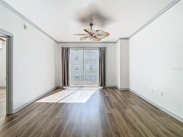 spare room with ornamental molding, ceiling fan, and dark wood-type flooring