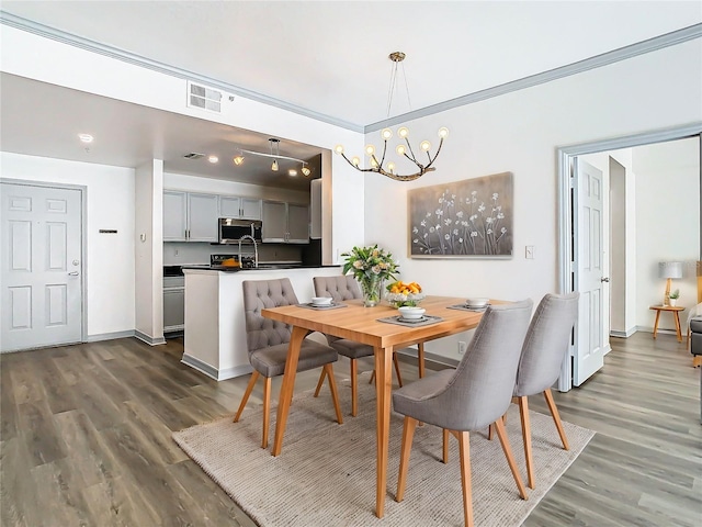 dining space featuring dark wood-type flooring and a chandelier