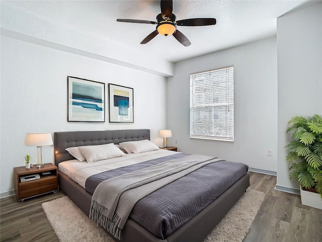 bedroom featuring ceiling fan and dark hardwood / wood-style floors