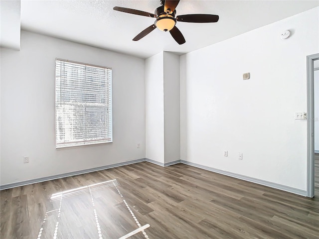 spare room featuring ceiling fan and hardwood / wood-style floors