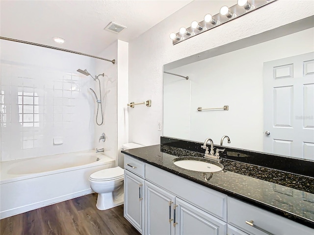 full bathroom featuring toilet, hardwood / wood-style flooring, shower / bath combination, and vanity