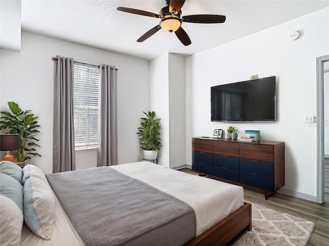 bedroom with ceiling fan and hardwood / wood-style flooring