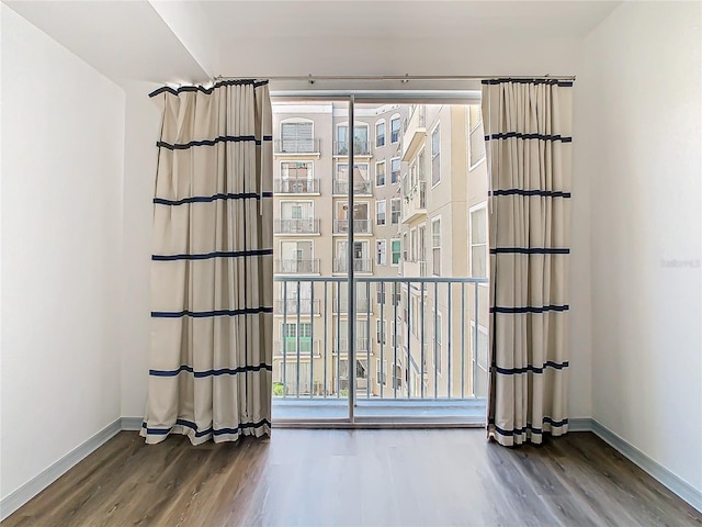 empty room with hardwood / wood-style floors and a wealth of natural light