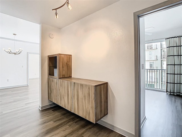 kitchen featuring dark hardwood / wood-style flooring and a chandelier