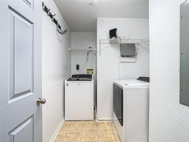 washroom featuring light tile patterned flooring and washing machine and clothes dryer