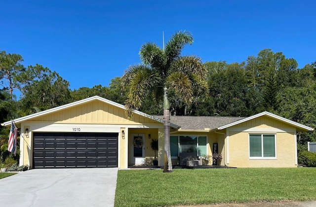 ranch-style home with a garage and a front lawn