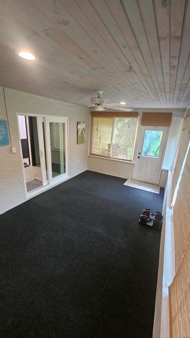 interior space featuring wooden ceiling and ceiling fan