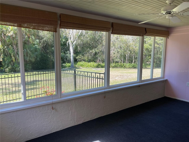 unfurnished sunroom featuring plenty of natural light and ceiling fan