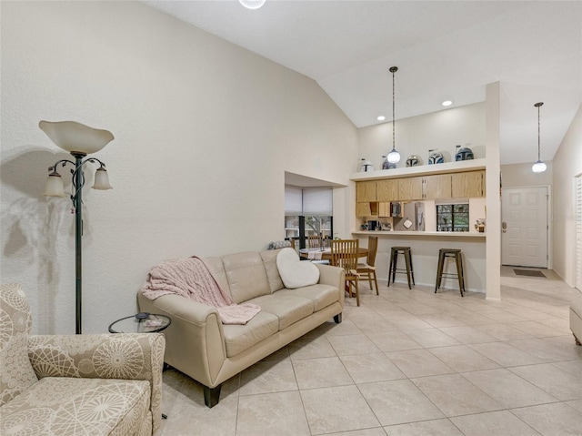 tiled living room with high vaulted ceiling