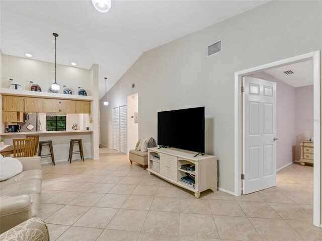 tiled living room with lofted ceiling