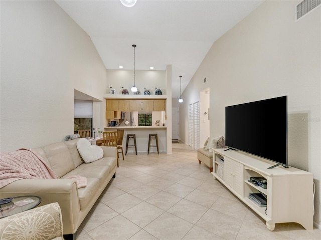 tiled living room with high vaulted ceiling