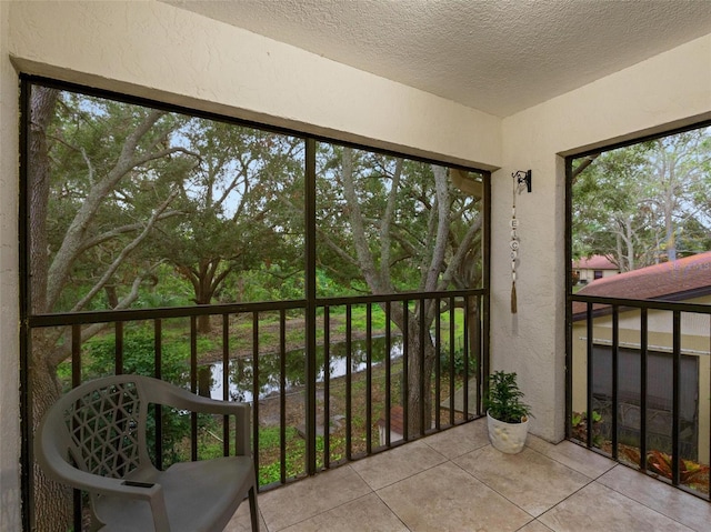 sunroom / solarium featuring a water view