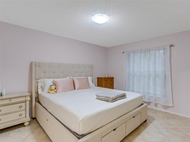 tiled bedroom featuring a textured ceiling