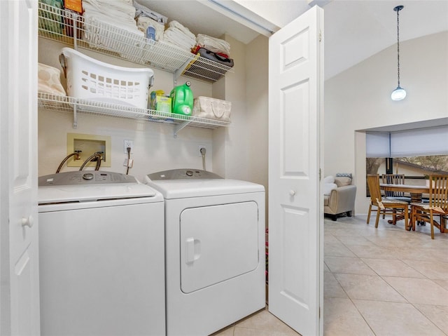 laundry room featuring separate washer and dryer and light tile patterned floors