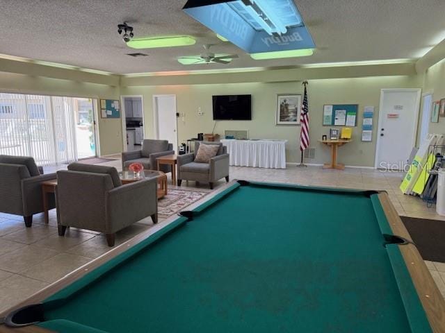 recreation room with tile patterned flooring, ceiling fan, pool table, and a textured ceiling