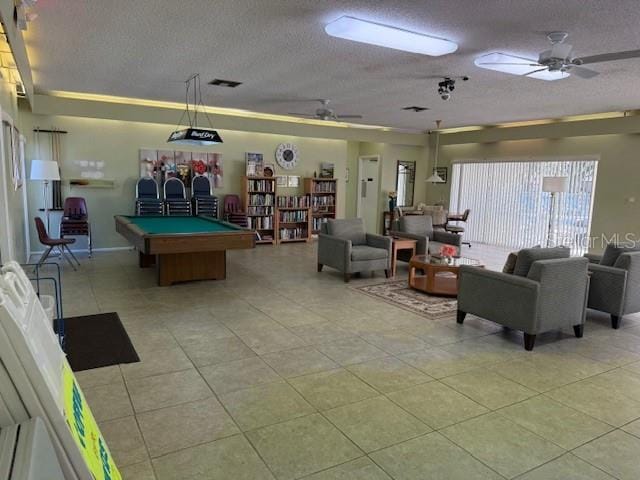 game room with ceiling fan, pool table, and a textured ceiling