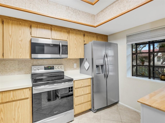 kitchen featuring light tile patterned floors, decorative backsplash, stainless steel appliances, and light brown cabinets