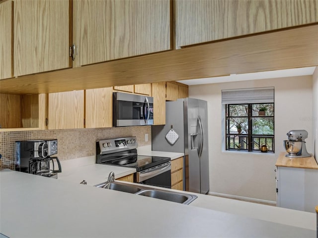 kitchen with light brown cabinetry, sink, decorative backsplash, and stainless steel appliances