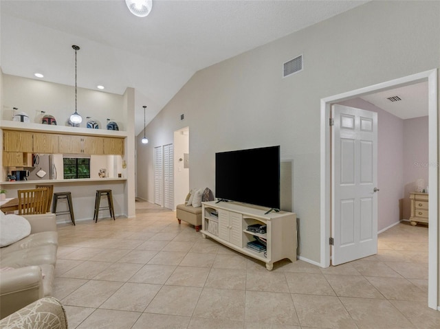 tiled living room featuring vaulted ceiling