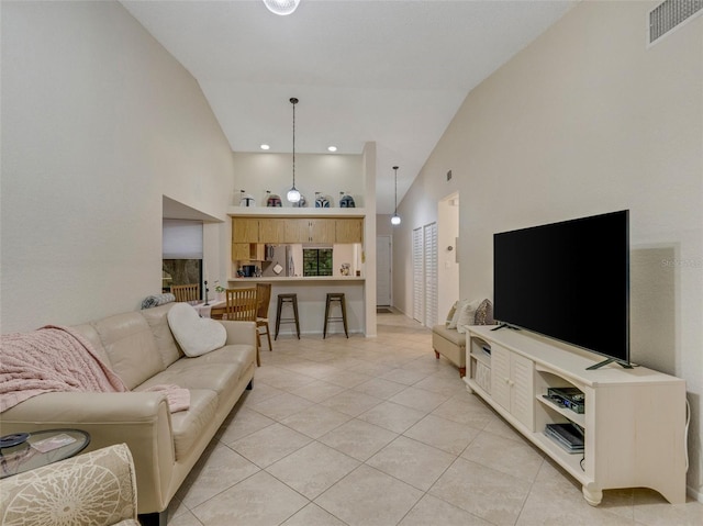 tiled living room featuring high vaulted ceiling