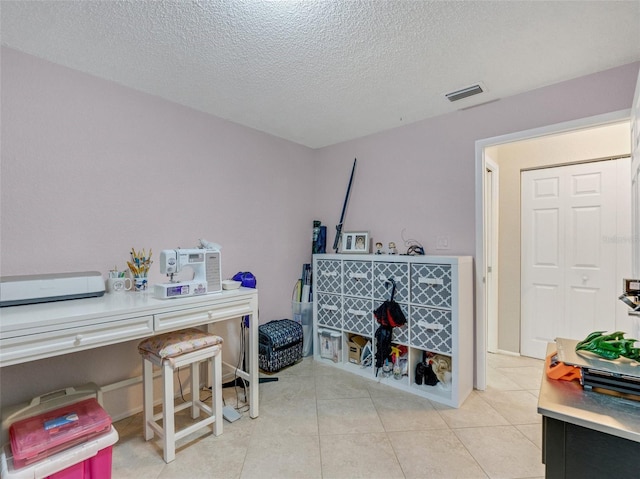 miscellaneous room with a textured ceiling