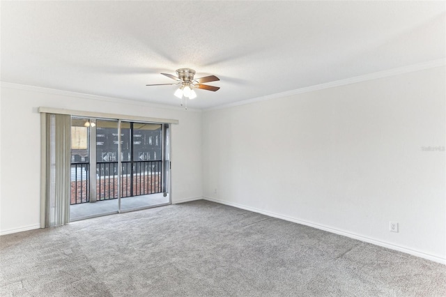 carpeted spare room featuring crown molding, ceiling fan, and a textured ceiling