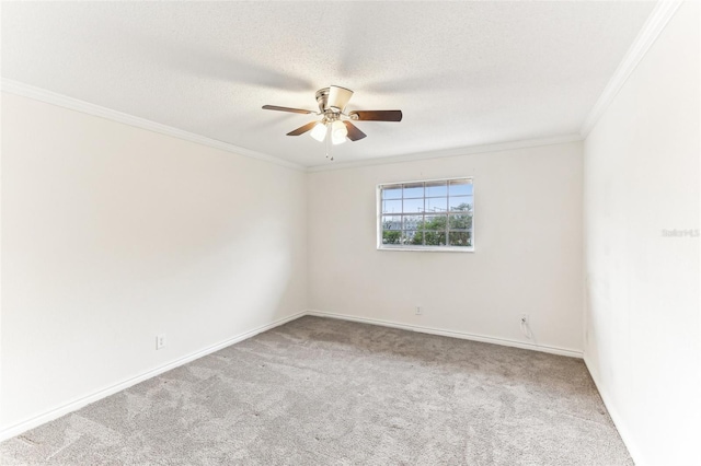 carpeted empty room featuring ornamental molding, ceiling fan, and a textured ceiling