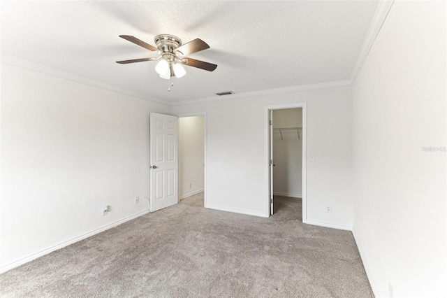 unfurnished room with crown molding, light carpet, ceiling fan, and a textured ceiling