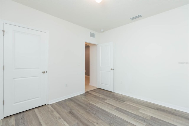 unfurnished bedroom with light wood-type flooring