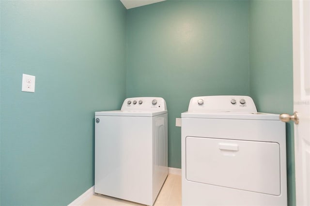 laundry area featuring separate washer and dryer and light tile patterned flooring