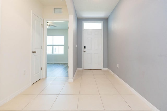 tiled foyer featuring ceiling fan