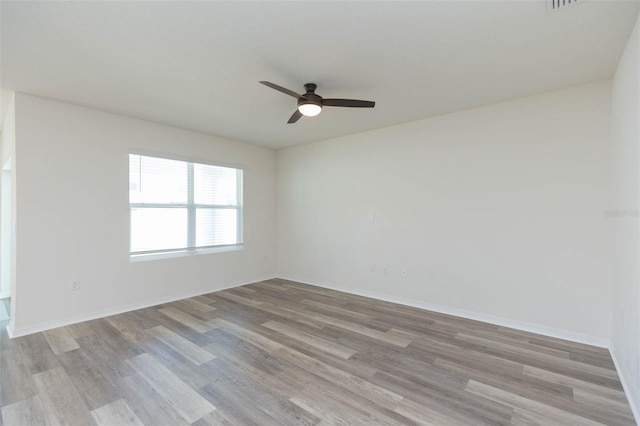 unfurnished room featuring ceiling fan and light hardwood / wood-style floors