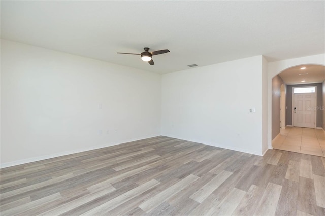 spare room featuring light wood-type flooring and ceiling fan