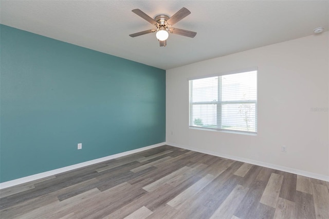 unfurnished room featuring hardwood / wood-style flooring and ceiling fan