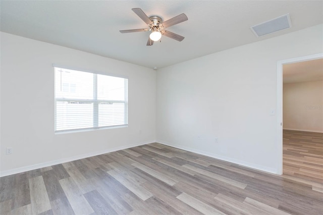 spare room featuring ceiling fan and light wood-type flooring