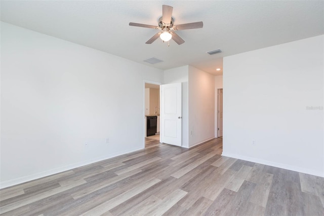 spare room featuring light wood-type flooring and ceiling fan