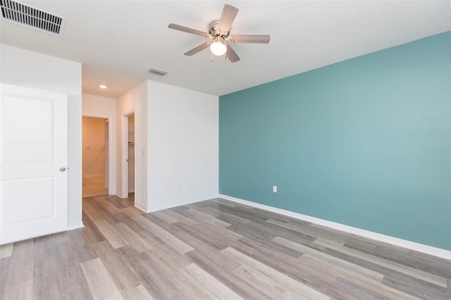 empty room featuring ceiling fan and light hardwood / wood-style floors