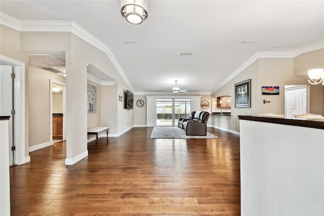 foyer featuring ceiling fan, crown molding, and wood-type flooring