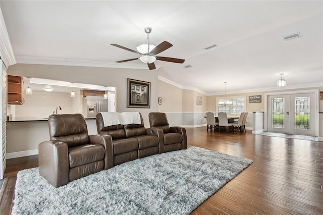 living room with french doors, dark hardwood / wood-style floors, ornamental molding, vaulted ceiling, and ceiling fan