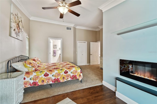 bedroom featuring ceiling fan, dark wood-type flooring, a closet, and crown molding