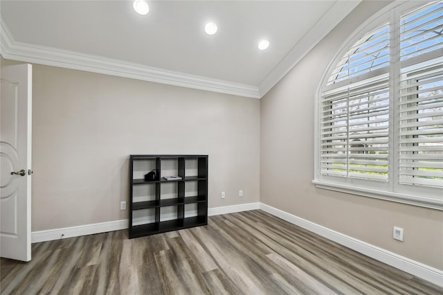 empty room with hardwood / wood-style flooring and ornamental molding