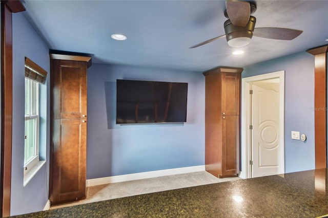 empty room featuring ceiling fan and plenty of natural light