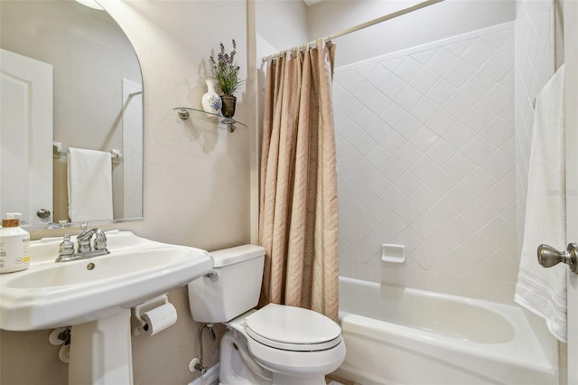 bathroom with toilet and shower / bath combo with shower curtain