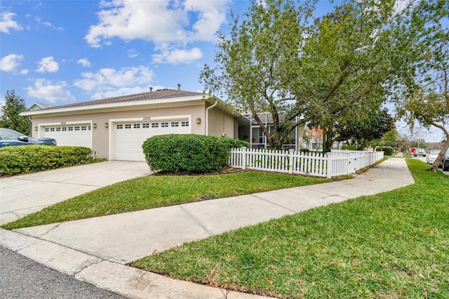 view of front of home with a garage and a front lawn