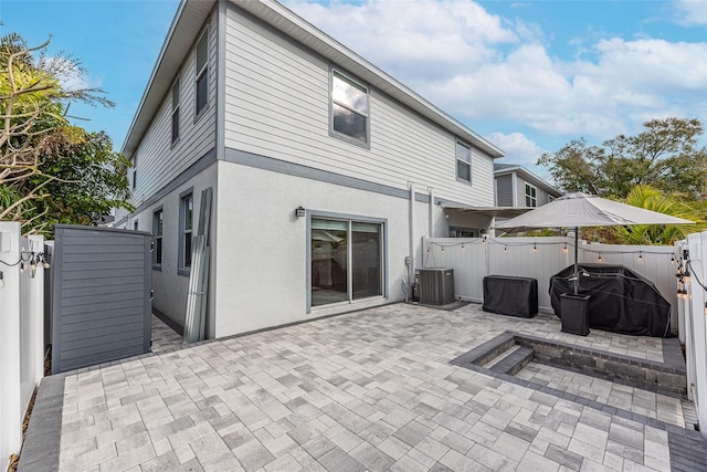 rear view of property with a patio area and cooling unit