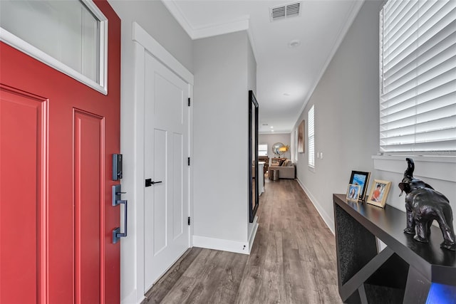 hallway featuring light hardwood / wood-style floors and crown molding