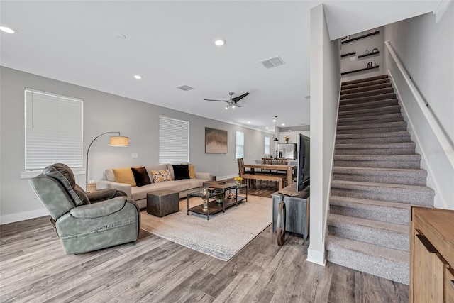 living room featuring hardwood / wood-style flooring and ceiling fan