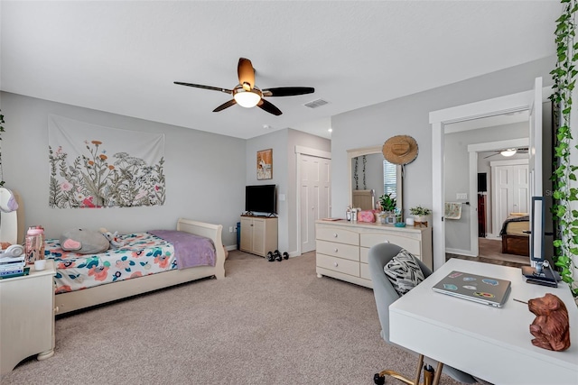 bedroom featuring ceiling fan, light colored carpet, and a closet