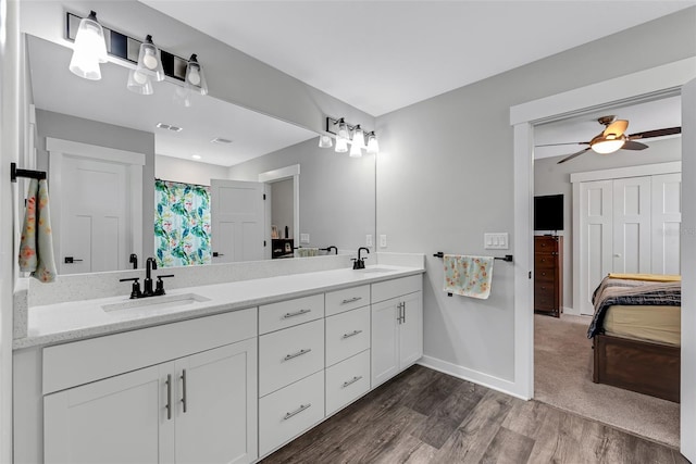 bathroom featuring ceiling fan, hardwood / wood-style flooring, and vanity