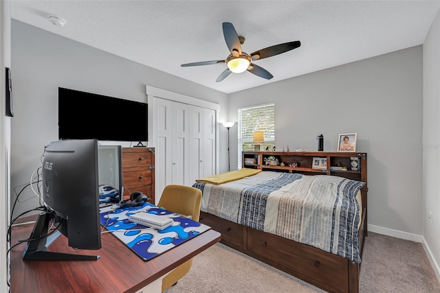 bedroom featuring light carpet, ceiling fan, and a closet